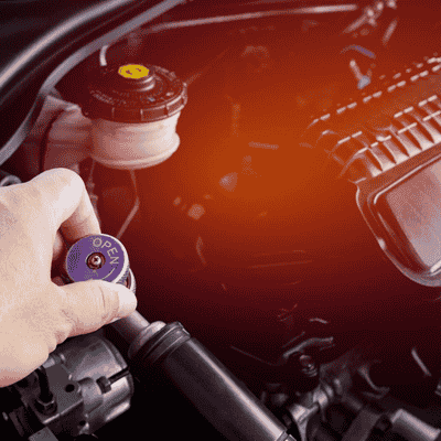 Technician performing a car air conditioning system check during routine aircon servicing.